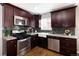 This updated kitchen is equipped with stainless steel appliances and plenty of cabinet space at 3320 N Madison St, Denver, CO 80205