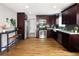 Updated kitchen with stainless appliances, granite countertops, and dark wood cabinets at 3320 N Madison St, Denver, CO 80205