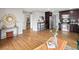 Spacious living room featuring hardwood floors, decorative mirror, and bar seating at 3320 N Madison St, Denver, CO 80205