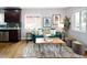 Living space with dark cabinets, windows, modern decor, and comfortable green sofa at 3320 N Madison St, Denver, CO 80205