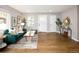 Bright living room with hardwood floors, green sofa, large windows, and contemporary decor at 3320 N Madison St, Denver, CO 80205