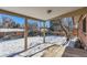 Covered patio overlooking a snow-covered backyard at 994 S Vivian Ct, Lakewood, CO 80228