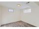 Simple, clean basement bedroom with carpet flooring and two windows at 994 S Vivian Ct, Lakewood, CO 80228