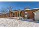 Brick house with a covered patio and backyard access at 994 S Vivian Ct, Lakewood, CO 80228