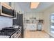 Modern kitchen with stainless steel appliances and white cabinetry at 994 S Vivian Ct, Lakewood, CO 80228