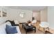 Living room with hardwood floors, modern furniture, and large mirror at 994 S Vivian Ct, Lakewood, CO 80228