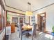 Charming dining room featuring a wooden table, gray chairs, and view to living room at 3412 Zuni St, Denver, CO 80211