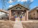 Brick home with a welcoming front porch and landscaping at 3412 Zuni St, Denver, CO 80211