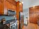 Modern kitchen boasts stainless steel appliances and ample wood cabinetry at 3412 Zuni St, Denver, CO 80211