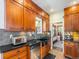 Modern kitchen with stainless steel appliances and wood cabinets at 3412 Zuni St, Denver, CO 80211