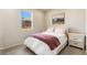 Bedroom with a comfortable bed, stylish nightstands, and a window with neighborhood views at 6150 Sugarloaf St, Brighton, CO 80601