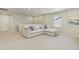 Spacious bonus room with plush carpeting and a comfortable sectional sofa with pillows at 6150 Sugarloaf St, Brighton, CO 80601