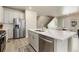 Modern kitchen featuring a stainless steel refrigerator and an island with a sink at 6150 Sugarloaf St, Brighton, CO 80601
