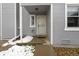 Home's covered front entryway featuring neutral siding, a storm door, and classic architecture at 9050 Zephyr Ct, Broomfield, CO 80021