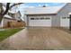 Attached two-car garage with a spacious driveway and exterior features in neutral tones at 9050 Zephyr Ct, Broomfield, CO 80021