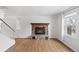 Living room featuring a stone fireplace, wood-look flooring, and neutral tones at 9050 Zephyr Ct, Broomfield, CO 80021