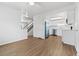 Open-concept living space featuring hardwood flooring, a staircase, and kitchen at 9050 Zephyr Ct, Broomfield, CO 80021