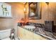 Bathroom with patterned wallpaper, marble countertops, sink, and vanity mirror at 1735 19Th St # 5B, Denver, CO 80202