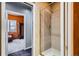 The glass enclosed shower contains neutral tiling with a decorative inset at 1735 19Th St # 5B, Denver, CO 80202
