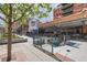 View of Denver Beer Co. building with outside tables and the building's silos in the background at 1735 19Th St # 5B, Denver, CO 80202