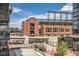 View of brick apartment complex with stadium in background; includes a walking bridge, city buildings, and sky at 1735 19Th St # 5B, Denver, CO 80202