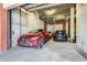Garage interior with three luxury vehicles and an overhead garage door and concrete walls at 1735 19Th St # 5B, Denver, CO 80202