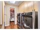 Modern laundry room with front loading washer/dryer and storage cabinets, adjacent to a pantry at 1735 19Th St # 5B, Denver, CO 80202
