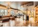 Open-concept living area with hardwood floors, chandeliers, a fireplace, and adjacent kitchen space at 1735 19Th St # 5B, Denver, CO 80202