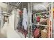 Storage closet in hallway with wire fencing, metal piping overhead, and many items being stored at 1735 19Th St # 5B, Denver, CO 80202