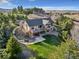 Aerial view of home displaying mature landscaping, backyard pond, and fire pit area at 501 Young Cir, Castle Rock, CO 80104
