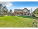 Spacious backyard with lush lawn and stone accents showcasing the home's exterior at 501 Young Cir, Castle Rock, CO 80104