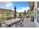 Outdoor deck featuring a dining table with umbrella and a grill, with mountain views at 501 Young Cir, Castle Rock, CO 80104