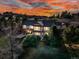A dusk view of the exterior of this luxurious home with manicured landscaping at 501 Young Cir, Castle Rock, CO 80104
