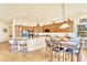 Open concept kitchen featuring wood cabinetry, granite counters, an island with seating, and breakfast table at 501 Young Cir, Castle Rock, CO 80104