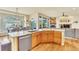Gourmet kitchen with granite counters, wood cabinets, stainless appliances, and view of a stone fireplace at 501 Young Cir, Castle Rock, CO 80104