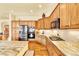 Spacious kitchen with wood cabinets, granite countertops, stainless steel appliances, and hardwood flooring at 501 Young Cir, Castle Rock, CO 80104