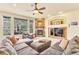 Bright living room with a stone fireplace, large windows, and a comfortable sectional sofa at 501 Young Cir, Castle Rock, CO 80104