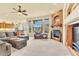 Inviting living room featuring a stone fireplace, large windows, and comfortable seating at 501 Young Cir, Castle Rock, CO 80104