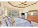 Comfortable main bedroom featuring natural light, a decorative ceiling, and a stone fireplace at 501 Young Cir, Castle Rock, CO 80104
