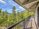 Enjoy stunning views of the lush forest and blue sky from this home's private balcony at 24354 Eagle Cliff Trl, Conifer, CO 80433