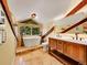 Bathroom with vaulted ceiling, skylight, and modern bathtub with wood beam accents and double sink at 24354 Eagle Cliff Trl, Conifer, CO 80433
