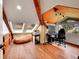 Attic room featuring a slanted ceiling, exposed beams, wood floors, natural light and gaming area, offering a relaxing retreat at 24354 Eagle Cliff Trl, Conifer, CO 80433