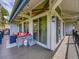The deck features cozy outdoor seating, modern lighting, and seamless access to the home's interior through large glass doors at 24354 Eagle Cliff Trl, Conifer, CO 80433
