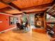 Dining room with wood beams, wood burning stove and views of the deck at 24354 Eagle Cliff Trl, Conifer, CO 80433