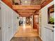 Welcoming entryway with wood beams, a wood burning stove, and views of the dining area at 24354 Eagle Cliff Trl, Conifer, CO 80433