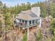 Elevated home boasts solar panels, modern design, and panoramic views, perched atop a rocky landscape at 24354 Eagle Cliff Trl, Conifer, CO 80433