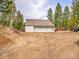 Spacious three-car garage with ample parking and storage, set amidst a scenic landscape at 24354 Eagle Cliff Trl, Conifer, CO 80433