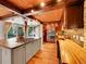 Gourmet kitchen featuring an island cooktop, wood beams, and stainless steel appliances at 24354 Eagle Cliff Trl, Conifer, CO 80433