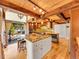 Modern kitchen featuring an island with seating, wood beam ceiling and stainless steel appliances at 24354 Eagle Cliff Trl, Conifer, CO 80433