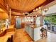 Kitchen with wood accents, stainless steel appliances, and a breakfast bar open to the deck at 24354 Eagle Cliff Trl, Conifer, CO 80433